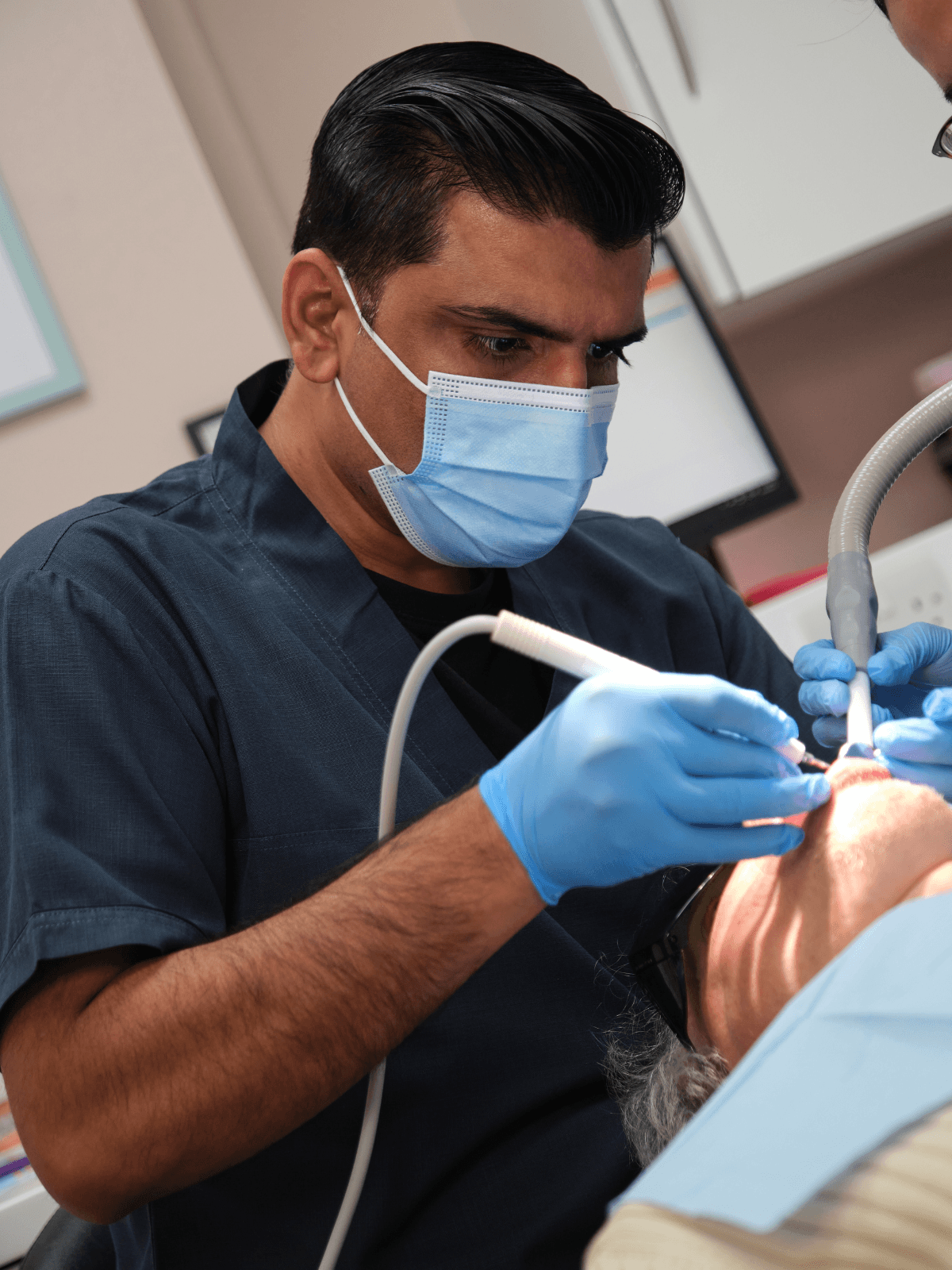 Emergency dentist treating a patient at Winchester Avenue Dental Surgery in Leicester